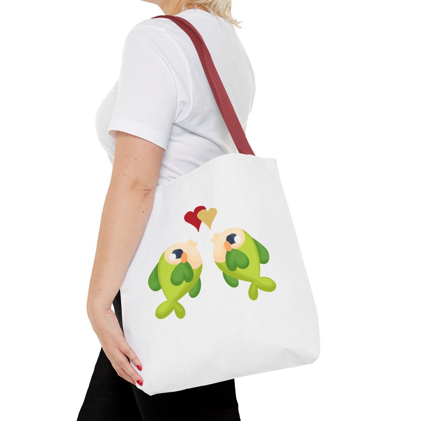 Two hearts float between the fish one red and one yellow. Tote Bag