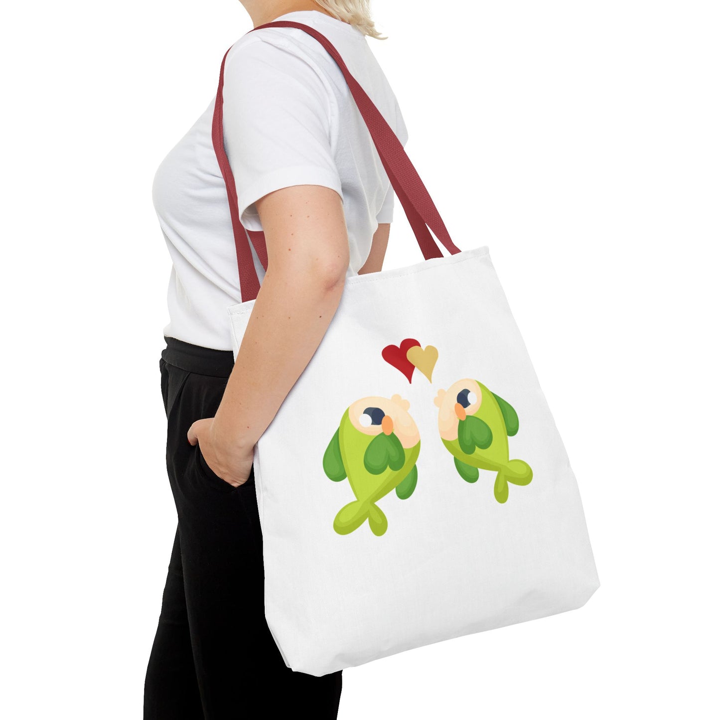 Two hearts float between the fish one red and one yellow. Tote Bag